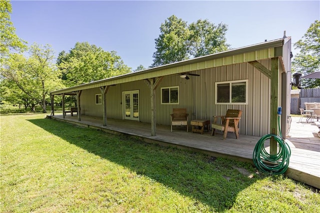 3931 Main St, Parsons, KS 67357 - rear view of property with a deck, french doors, a yard, a ceiling fan, and board and batten siding
