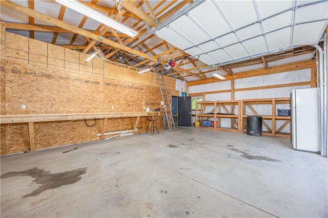 3931 Main St, Parsons, KS 67357 - garage with freestanding refrigerator and a garage door opener