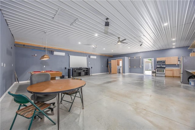 3931 Main St, Parsons, KS 67357 - garage featuring freestanding refrigerator, an AC wall unit, and baseboards