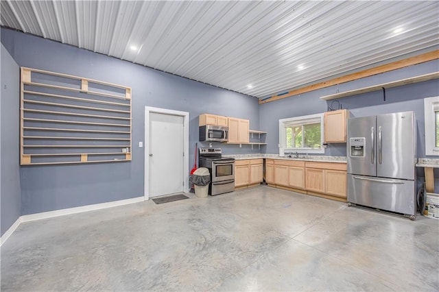 3931 Main St, Parsons, KS 67357 - kitchen with stainless steel appliances, light brown cabinets, finished concrete flooring, open shelves, and light countertops