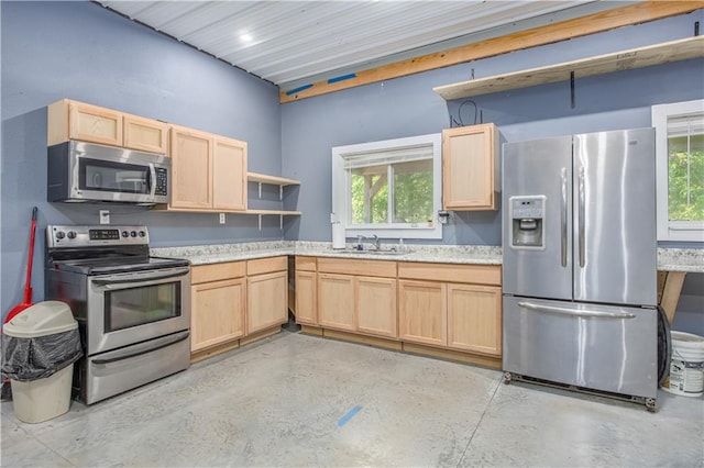 3931 Main St, Parsons, KS 67357 - kitchen with stainless steel appliances, light brown cabinets, and finished concrete flooring