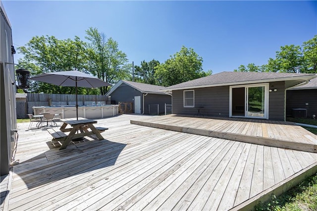 3931 Main St, Parsons, KS 67357 - wooden terrace featuring central air condition unit and outdoor dining area