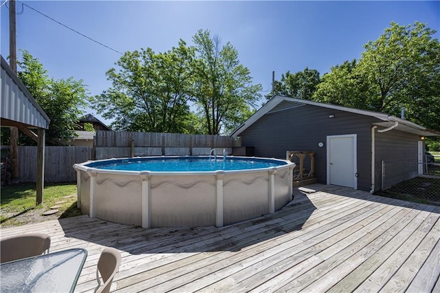 3931 Main St, Parsons, KS 67357 - view of swimming pool featuring a wooden deck and a fenced backyard