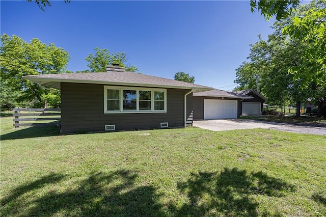 3931 Main St, Parsons, KS 67357 - view of front of home featuring driveway, a garage, and a chimney