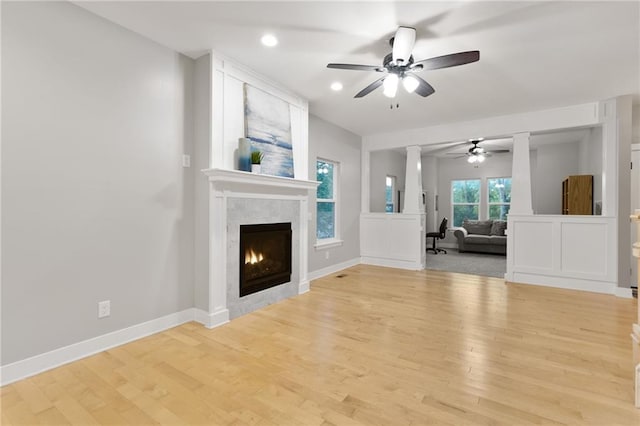 13807 W 47th Ter, Shawnee, KS 66216 - unfurnished living room featuring ceiling fan, wood finished floors, a warm lit fireplace, recessed lighting, and baseboards
