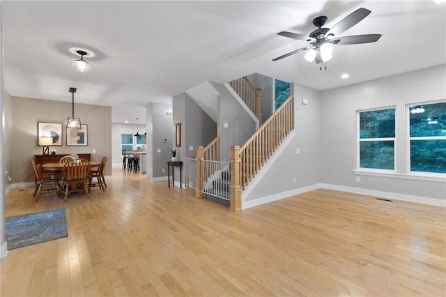 13807 W 47th Ter, Shawnee, KS 66216 - living area featuring light wood-type flooring, a ceiling fan, stairway, baseboards, and recessed lighting