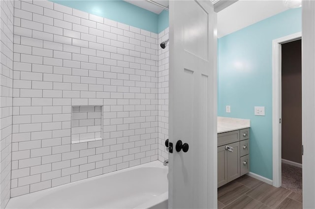 13807 W 47th Ter, Shawnee, KS 66216 - bathroom featuring vanity, bathtub / shower combination, wood finish floors, and baseboards