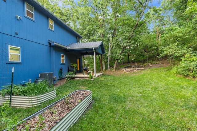 13807 W 47th Ter, Shawnee, KS 66216 - view of green lawn with central air condition unit, a garden, and a patio area