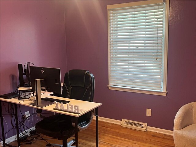 8425 N Tracy Ave, Kansas City, MO 64155 - home office featuring wood finished floors, baseboards, and healthy amount of natural light