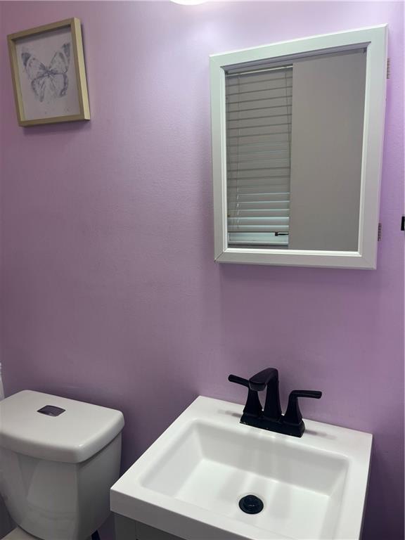 8425 N Tracy Ave, Kansas City, MO 64155 - bathroom featuring a sink and toilet
