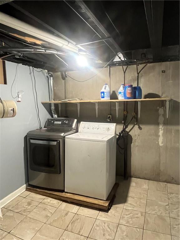 8425 N Tracy Ave, Kansas City, MO 64155 - laundry room featuring washing machine and dryer and baseboards