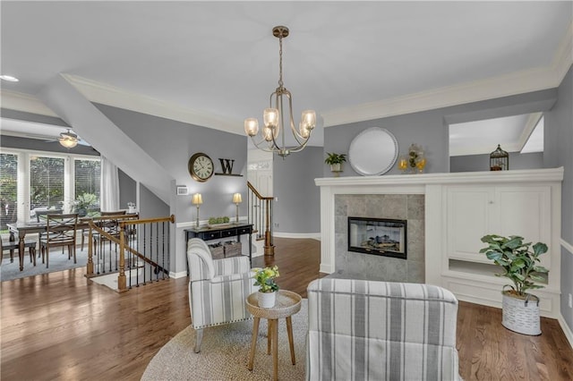 7208 Oakview St, Shawnee, KS 66216 - living area with ornamental molding, wood finished floors, baseboards, ceiling fan, and a tiled fireplace
