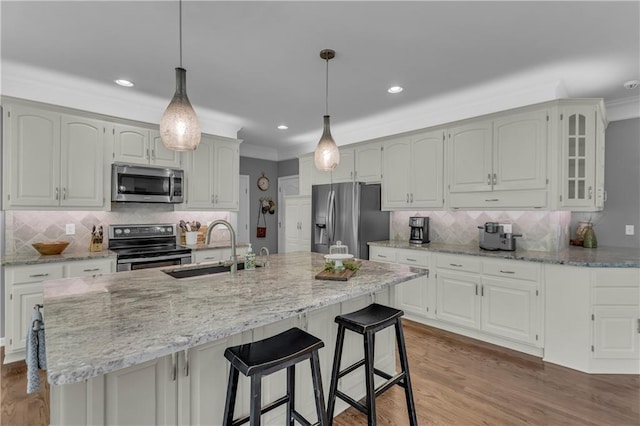 7208 Oakview St, Shawnee, KS 66216 - kitchen featuring stainless steel appliances, a sink, ornamental molding, tasteful backsplash, and light stone counters