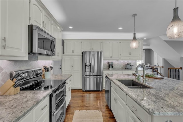 7208 Oakview St, Shawnee, KS 66216 - kitchen with appliances with stainless steel finishes, a sink, light stone countertops, recessed lighting, and dark wood finished floors