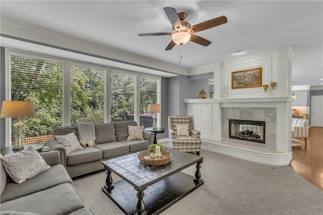 7208 Oakview St, Shawnee, KS 66216 - living room with a tile fireplace, a ceiling fan, and crown molding