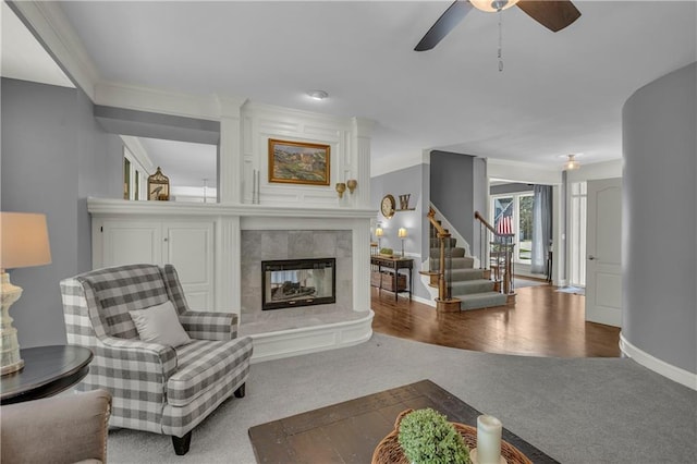 7208 Oakview St, Shawnee, KS 66216 - carpeted living room with a tile fireplace, stairway, a ceiling fan, and baseboards