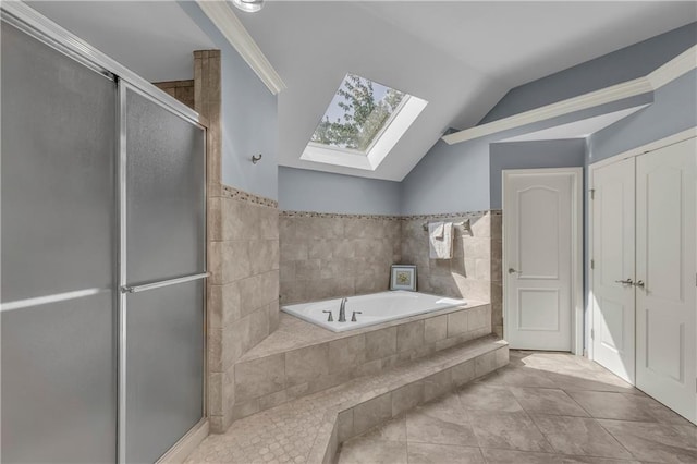 7208 Oakview St, Shawnee, KS 66216 - bathroom with a skylight, a garden tub, a stall shower, vaulted ceiling, and tile patterned floors