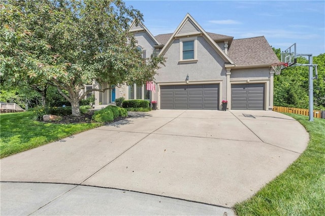 7208 Oakview St, Shawnee, KS 66216 - view of front facade with concrete driveway, stucco siding, a front yard, a shingled roof, and an attached garage
