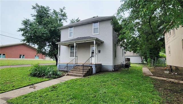 403 S St, Iola, KS 66749 - american foursquare style home with a front yard and cooling unit