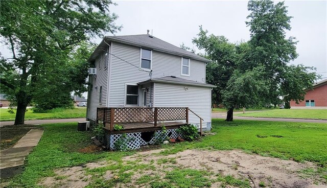 403 S St, Iola, KS 66749 - rear view of house featuring a yard, a deck, and cooling unit
