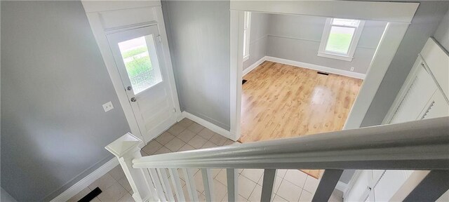 403 S St, Iola, KS 66749 - doorway with baseboards and light wood-style flooring