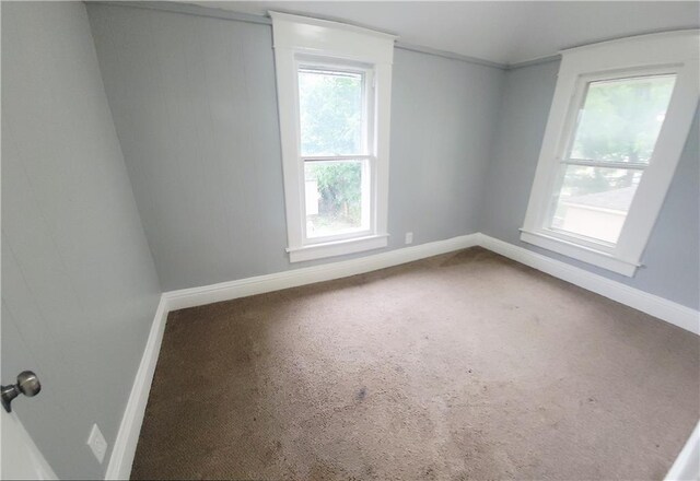 403 S St, Iola, KS 66749 - carpeted empty room with baseboards