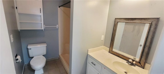 403 S St, Iola, KS 66749 - full bathroom featuring toilet, vanity, a shower, tile patterned floors, and baseboards
