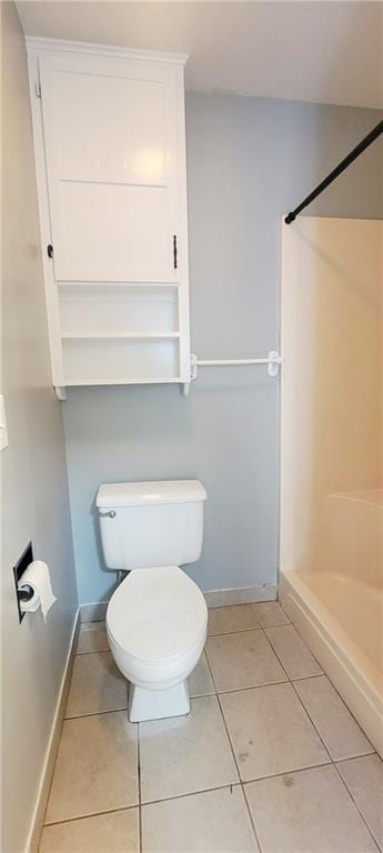 403 S St, Iola, KS 66749 - full bathroom with toilet, a shower, tile patterned flooring, and baseboards