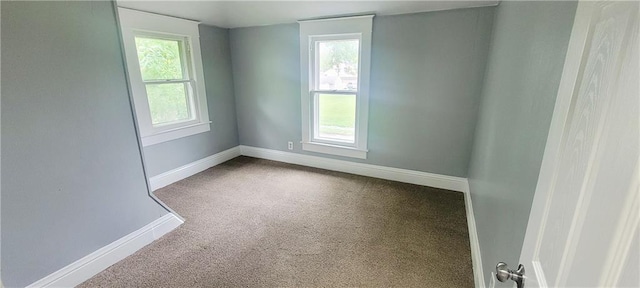 403 S St, Iola, KS 66749 - carpeted empty room featuring baseboards