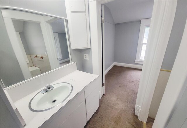 403 S St, Iola, KS 66749 - bathroom featuring vanity, lofted ceiling, and baseboards