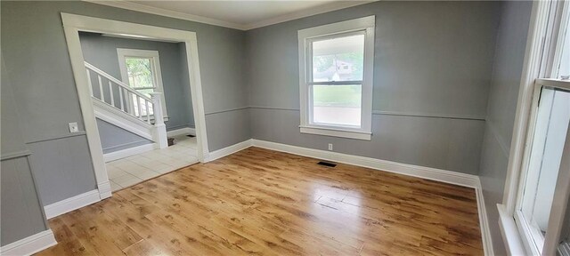 403 S St, Iola, KS 66749 - unfurnished room featuring ornamental molding, wood finished floors, stairs, and baseboards