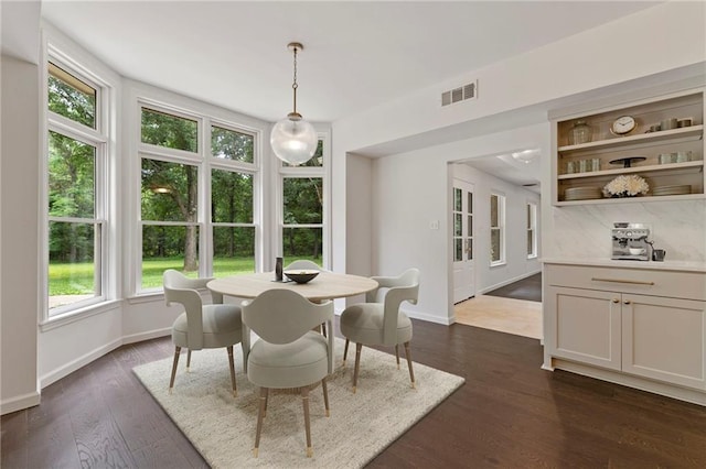 1810 S 98th St, Edwardsville, KS 66111 - dining area with baseboards and dark wood finished floors