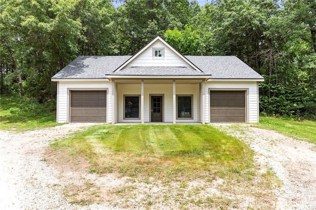 1810 S 98th St, Edwardsville, KS 66111 - view of front of home featuring a shingled roof, a garage, and dirt driveway