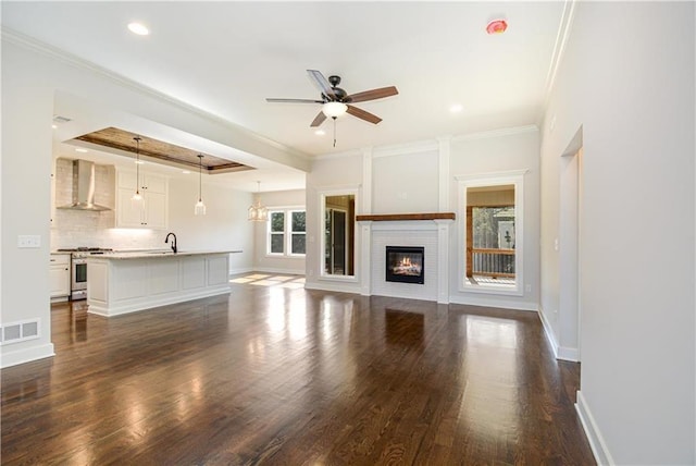22900 S Ridgeview Dr, Peculiar, MO 64078 - unfurnished living room with ceiling fan, dark wood-style flooring, a sink, a glass covered fireplace, and baseboards