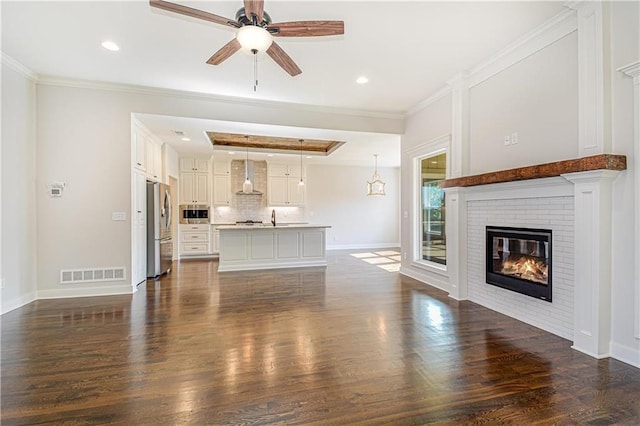 22900 S Ridgeview Dr, Peculiar, MO 64078 - unfurnished living room with a ceiling fan, baseboards, dark wood finished floors, a brick fireplace, and recessed lighting