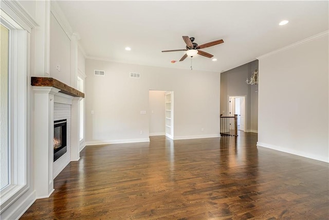 22900 S Ridgeview Dr, Peculiar, MO 64078 - unfurnished living room with a ceiling fan, a glass covered fireplace, recessed lighting, ornamental molding, and dark wood finished floors