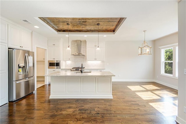 22900 S Ridgeview Dr, Peculiar, MO 64078 - kitchen featuring appliances with stainless steel finishes, wall chimney range hood, a tray ceiling, decorative backsplash, and a sink