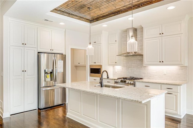 22900 S Ridgeview Dr, Peculiar, MO 64078 - kitchen with stainless steel appliances, wall chimney range hood, a raised ceiling, a sink, and decorative backsplash