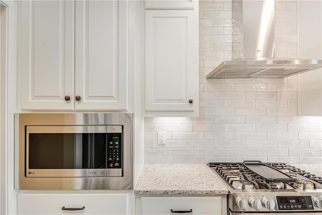 22900 S Ridgeview Dr, Peculiar, MO 64078 - kitchen with wall chimney range hood, appliances with stainless steel finishes, white cabinets, and decorative backsplash
