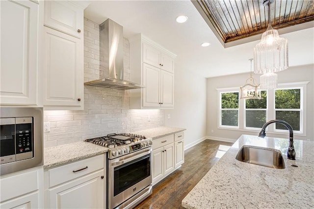22900 S Ridgeview Dr, Peculiar, MO 64078 - kitchen with appliances with stainless steel finishes, wall chimney range hood, a sink, baseboards, and light stone counters