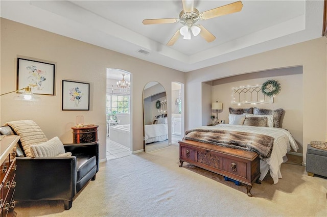 3222 SW Shadow Brook Dr, Blue Springs, MO 64015 - bedroom featuring carpet, a tray ceiling, arched walkways, ensuite bathroom, and a chandelier