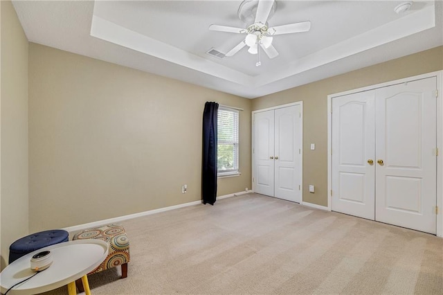 3222 SW Shadow Brook Dr, Blue Springs, MO 64015 - unfurnished bedroom with two closets, a raised ceiling, light colored carpet, and a ceiling fan
