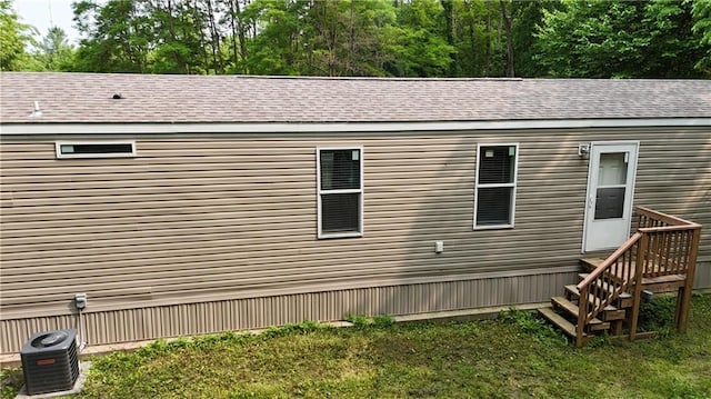 17922 County Road 361, Savannah, MO 64485 - view of property exterior with central AC unit, a lawn, and a shingled roof
