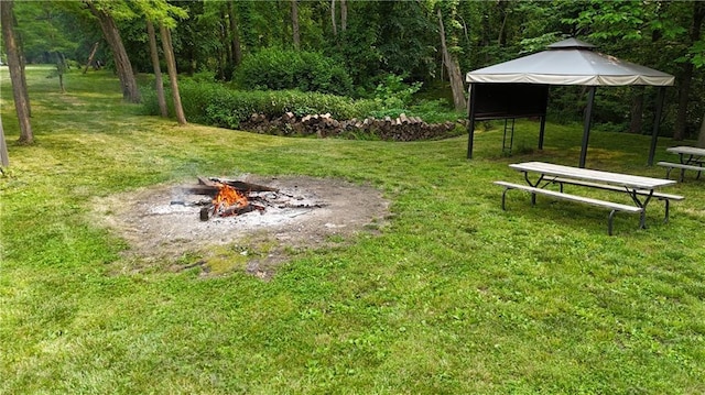 17922 County Road 361, Savannah, MO 64485 - view of green lawn with an outdoor fire pit and a gazebo