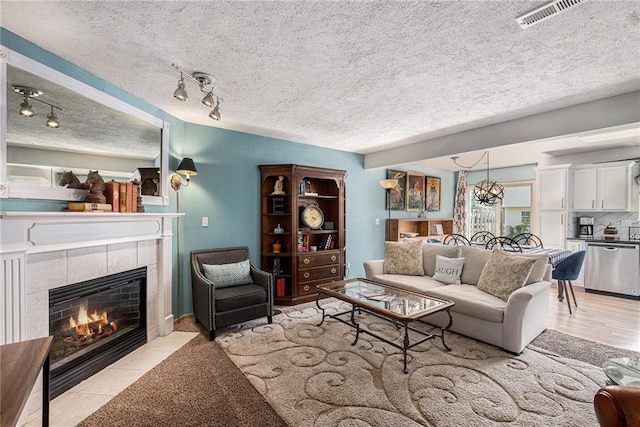 1404 SE Lexington Ave, Lees Summit, MO 64081 - living area with a fireplace and a textured ceiling