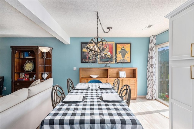 1404 SE Lexington Ave, Lees Summit, MO 64081 - dining room featuring a textured ceiling, a chandelier, light wood finished floors, and rail lighting