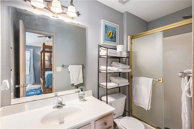 1404 SE Lexington Ave, Lees Summit, MO 64081 - ensuite bathroom featuring a shower stall, vanity, toilet, and ceiling fan