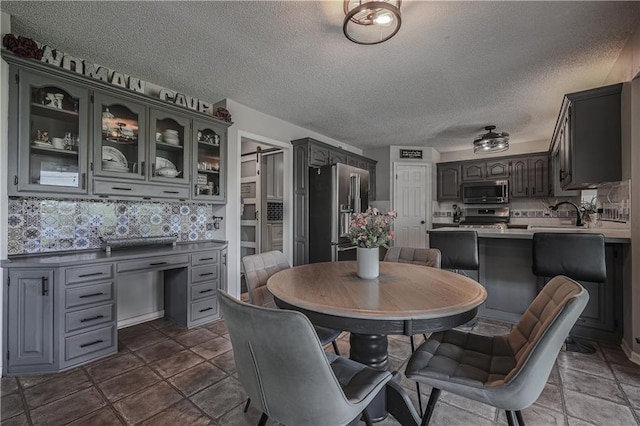 11702 E 246th St, Peculiar, MO 64078 - dining room featuring a textured ceiling and a desk