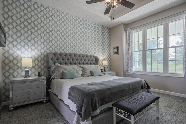 11702 E 246th St, Peculiar, MO 64078 - bedroom featuring wallpapered walls, dark carpet, an accent wall, and a ceiling fan