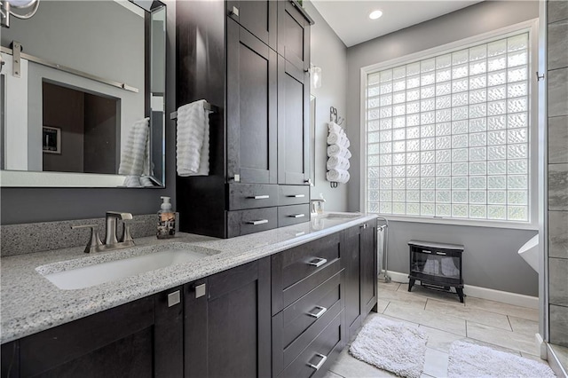 11702 E 246th St, Peculiar, MO 64078 - full bath with double vanity, a wood stove, and recessed lighting